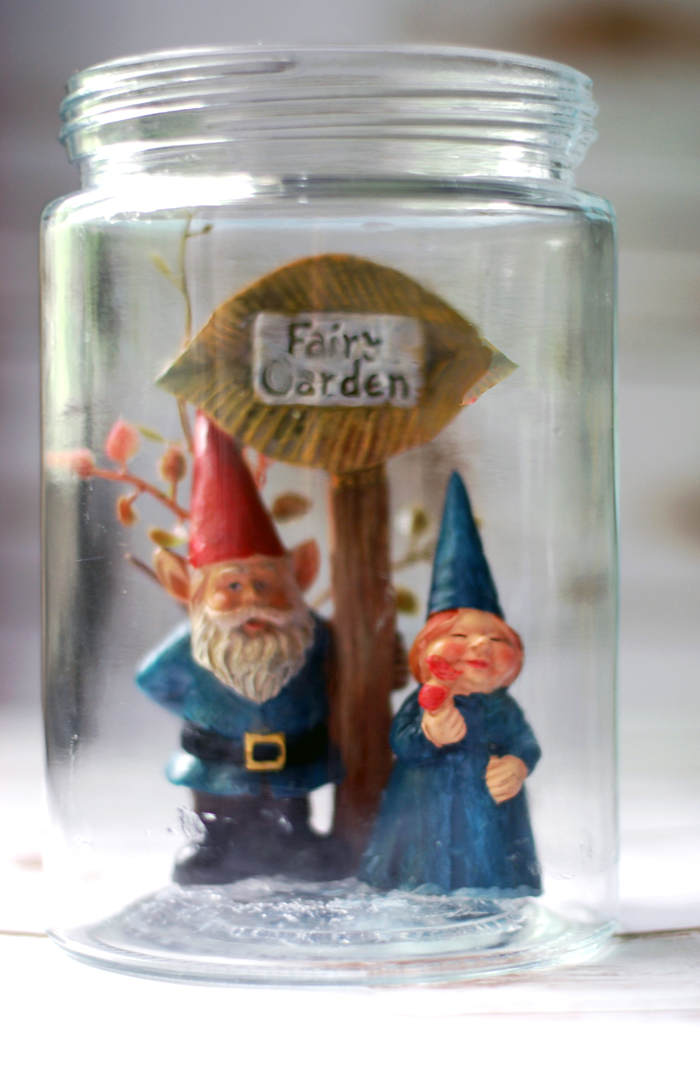 gnome couple glued to bottom of the jar