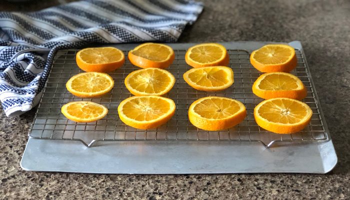 orange slices on a baking sheet and cookie drying rack